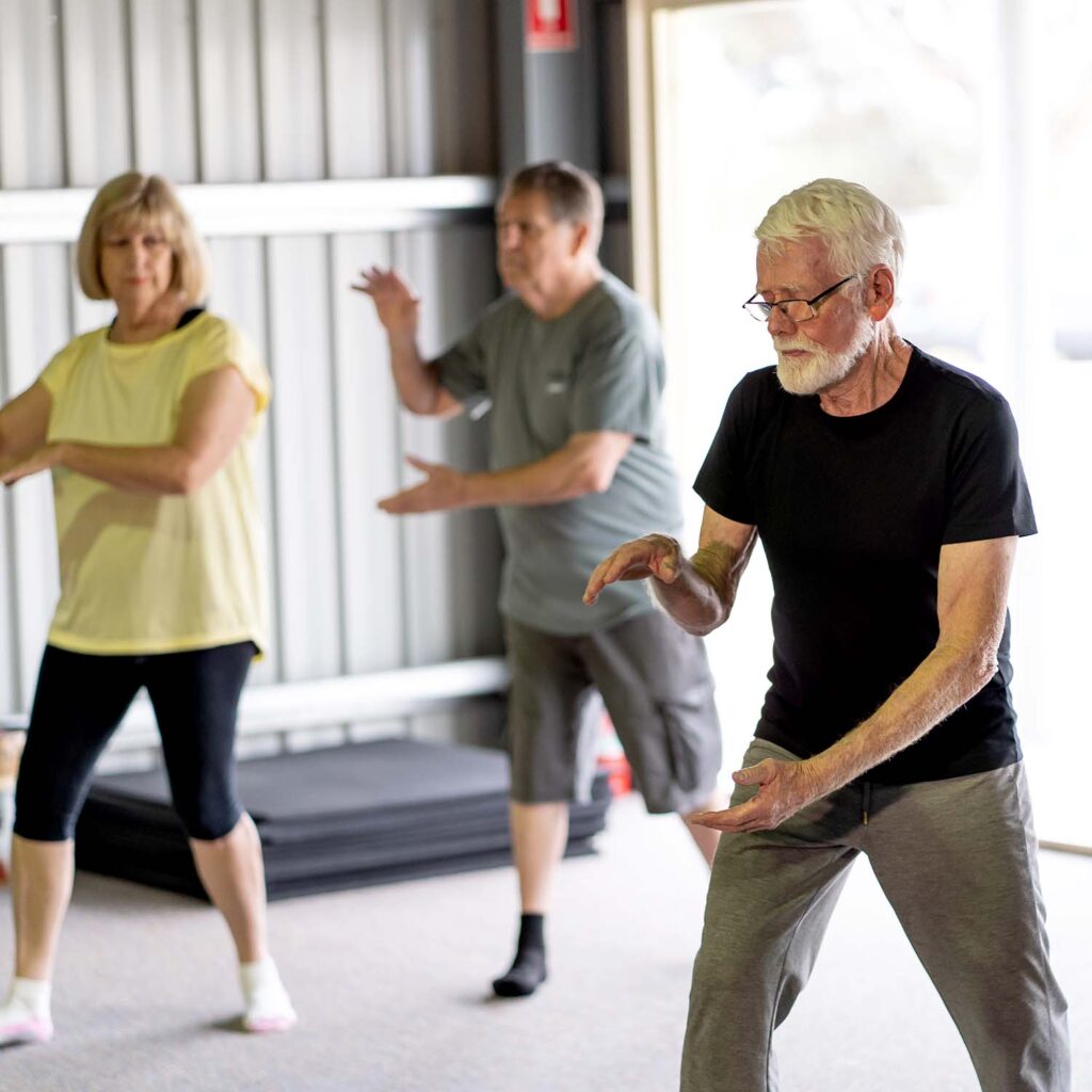 Showing therapist and patient during a group martial arts class for Parkinson's patients