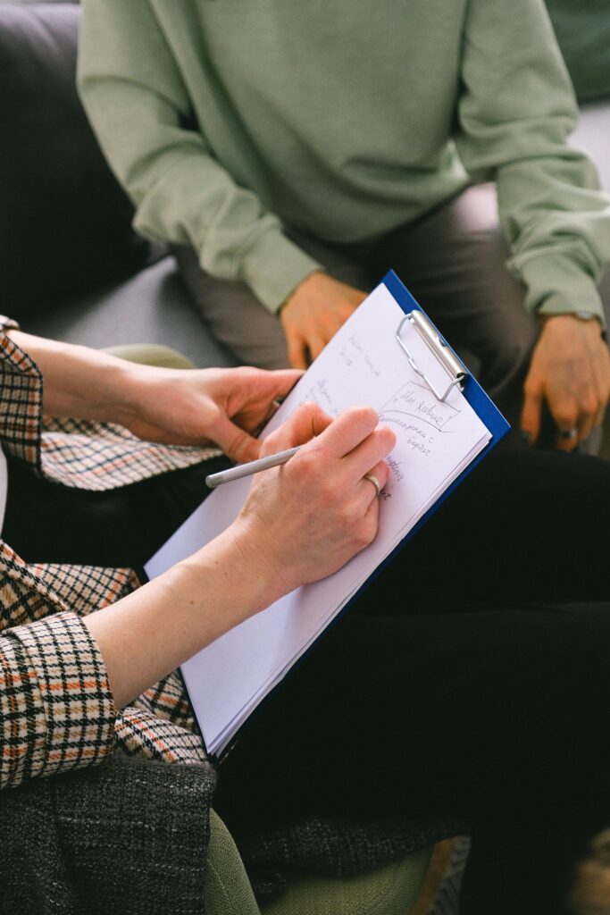 Close-up of a therapist taking notes during a PCIT assessment